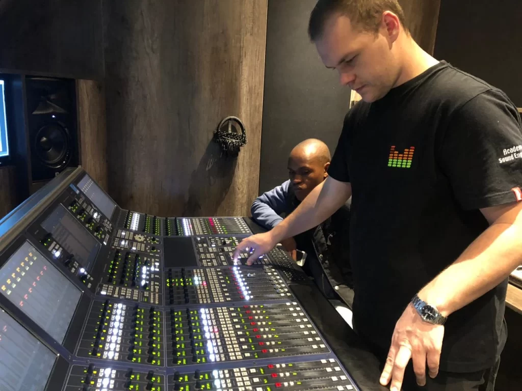 ASE students working on a professional mixing console